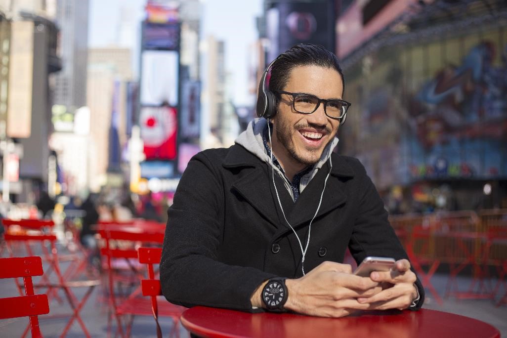 Man sitting wearing headphones and glasses